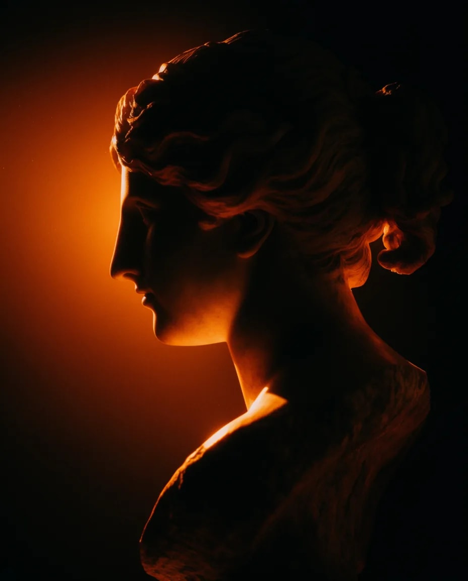 Roman marble bust in profile, backlit by amber light